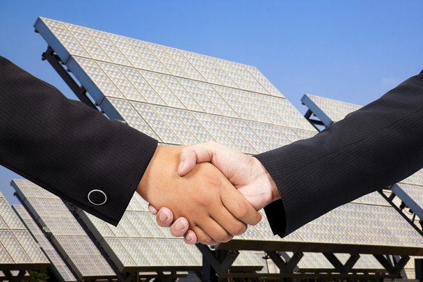 Businessman shaking hand before Solar power plant - Photo, Image