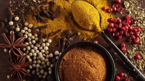 close up of various colorful spices rotating on wooden table top view - Footage, Video