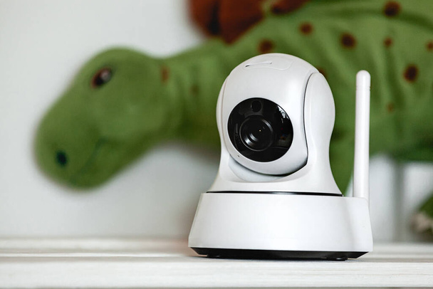 IP camera on the shelf with toys, serving as a baby monitor - Photo, Image