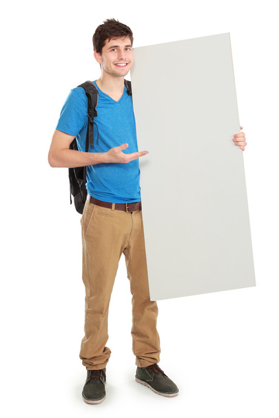 young male student holding white blank board - Zdjęcie, obraz