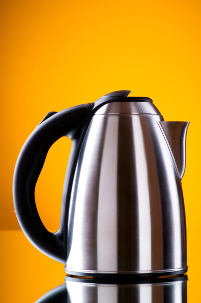 Shiny kettle against the colorful gradient background - Foto, Imagen