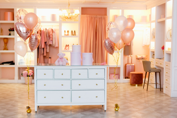 Dressing room, changing room, clothes rack in pink and peach colors with balloons. - Photo, Image