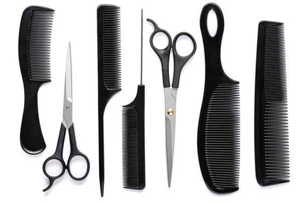 black hair combs of various types and scissors for cutting hair on a white isolated background - Photo, Image