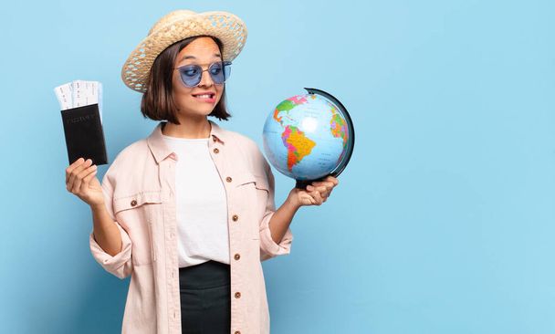 young pretty traveler woman with a world globe map. travel or holidays concept - 写真・画像
