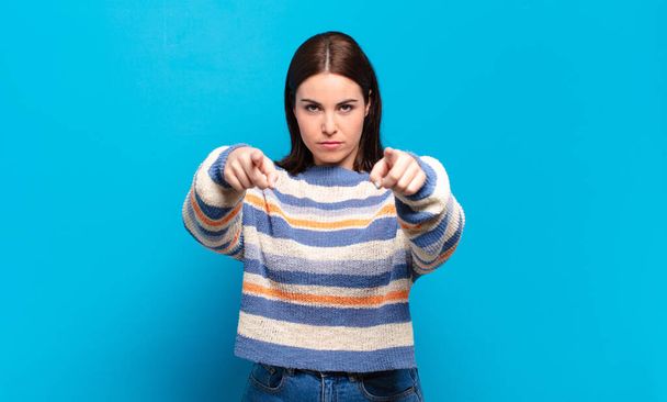 young pretty casual woman pointing forward at camera with both fingers and angry expression, telling you to do your duty - Фото, изображение