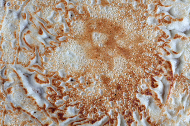 Achtergrond van een gebakken pannenkoeken oppervlak getextureerd - Foto, afbeelding