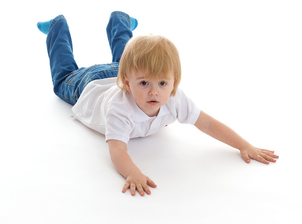 Portrait of a cute little boy lying on floor - Foto, Imagem