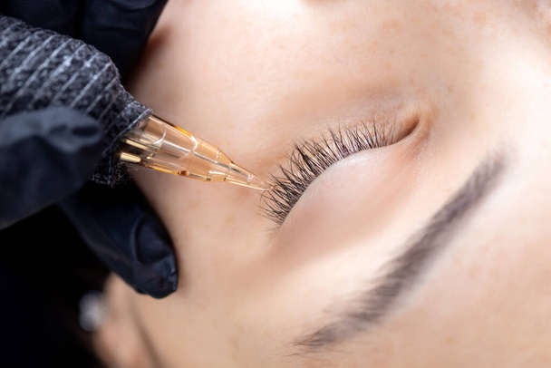 Contouring woman eye with permanent make-up, black eyeliner line - Photo, Image