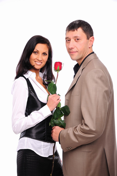 Young man gives his girlfriend a rose - Zdjęcie, obraz