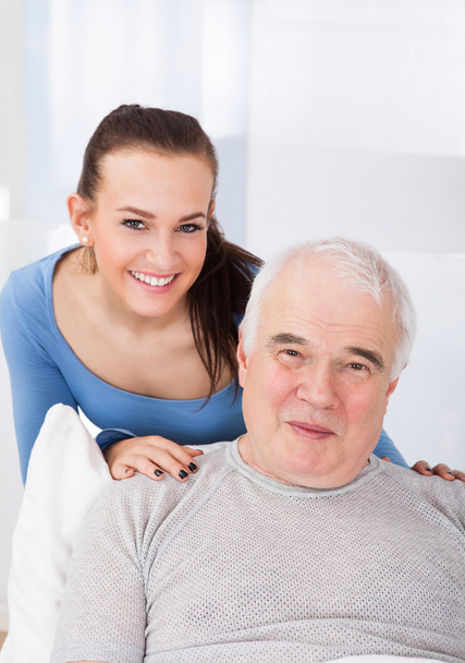 Portrait Of Happy Caregiver With Senior Man - Foto, Imagen
