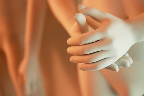 horizontal photo of a white mannequin's hands with orange lights - Valokuva, kuva