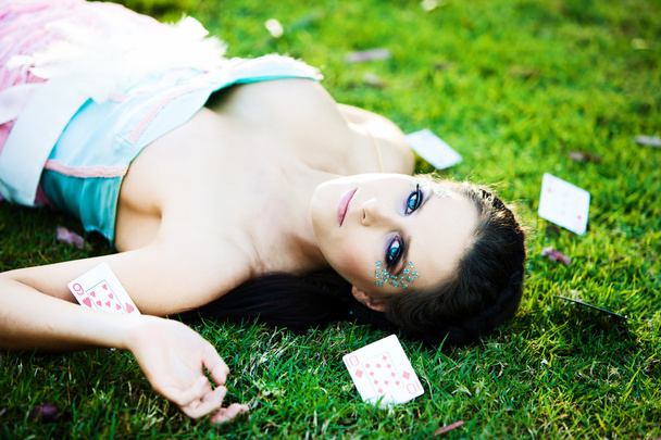 Young mysterious woman with cards in the grass - Foto, afbeelding
