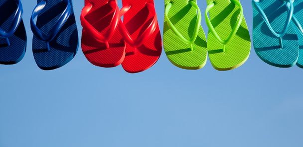Row of flipflops against a blue sky - Photo, image
