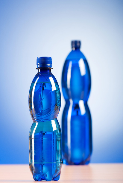 Bottle of water against colorful gradient background - 写真・画像