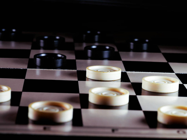 checkerboard with checkers. Game concept. Board game. Hobby. checkers on the playing field for a game. - Photo, Image