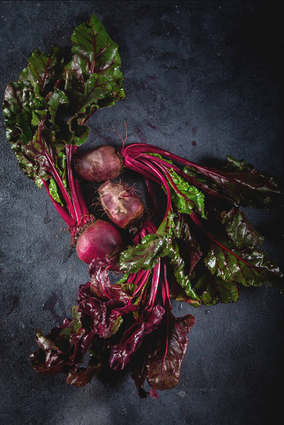 Fresh organic beet, beetroot. Grey background. Copy space. Top view. Beetroot with herbage on dark background. - Photo, Image