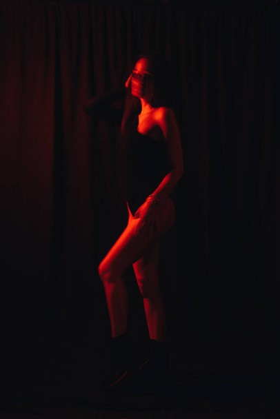 retrato borroso de una niña con trastornos mentales con luz de neón roja - Foto, imagen