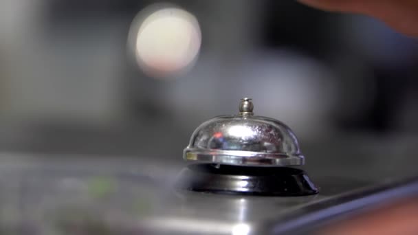 Hand ringing silver counter bell with blurry background - Footage, Video