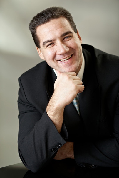 Attractive businessman in black suit - Foto, afbeelding