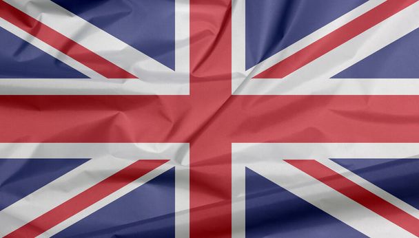 Fabric flag of The Union Jack. Crease of Union flag background, it is the national flag of the United Kingdom, white and red cross color on blue. - Photo, Image