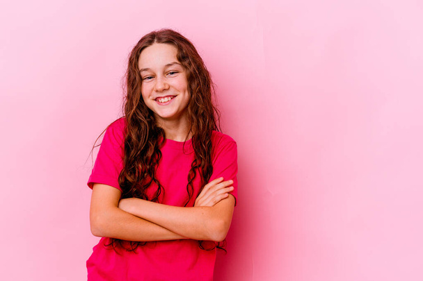Little caucasian girl isolated on pink background smiling confident with crossed arms. - Photo, Image
