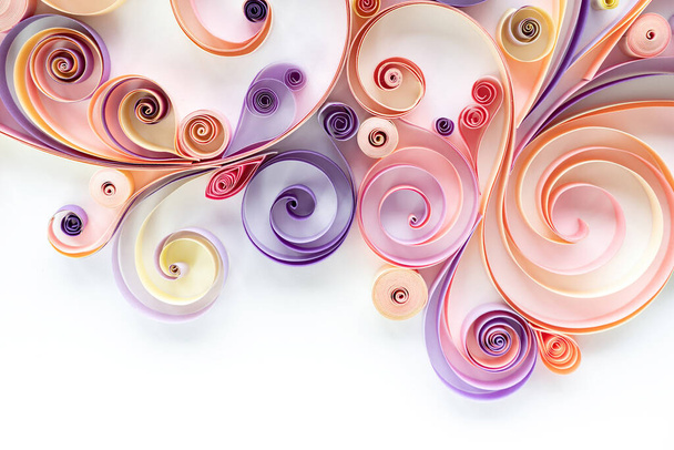 Abstract floral background from quilling paper colored stripes on a white background with copy space. Filigree paper art hobby. Panel from quilling paper in pink and purple tones - Photo, Image