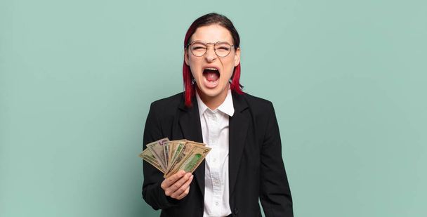 young attractive red hair woman shouting aggressively, looking very angry, frustrated, outraged or annoyed, screaming no. money concept - Φωτογραφία, εικόνα