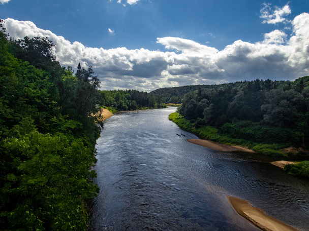 View to river Gauja surrounded by forest in summer season in July in Sigulda in Latvia - Photo, Image