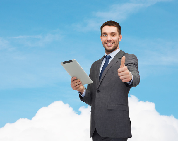 Smiling businessman with tablet pc computer - Photo, image