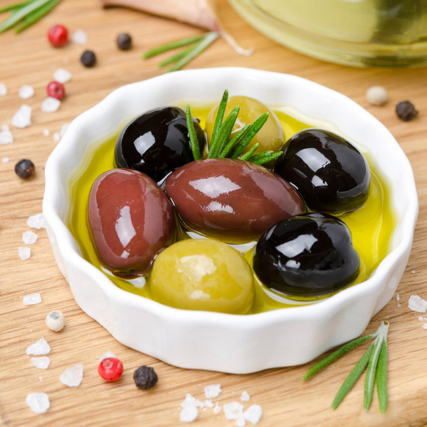assorted olives in olive oil, top view - Fotó, kép