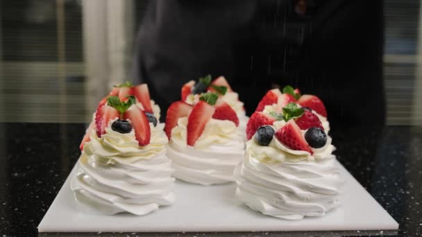 The pastry chef sprinkle powdered sugar on Anna Pavlovas mini cakes. - Footage, Video