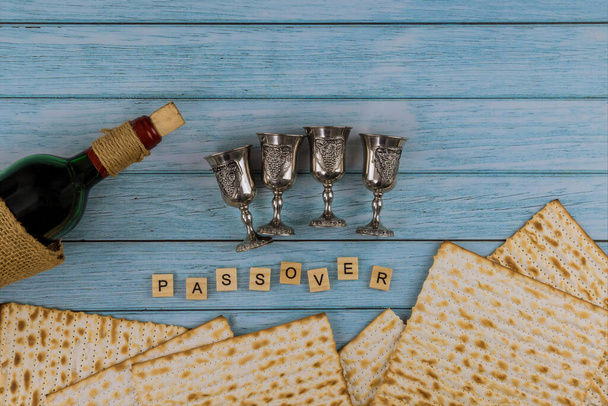Matzoh jewish holiday red kosher glasses wine with a of matzah a Passover Haggadah - Photo, Image