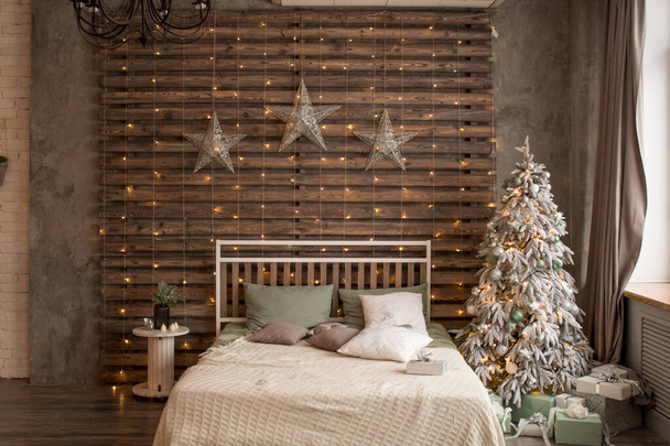 Bed with New Years decorations. New Years interior. Christmas tree. - Photo, Image