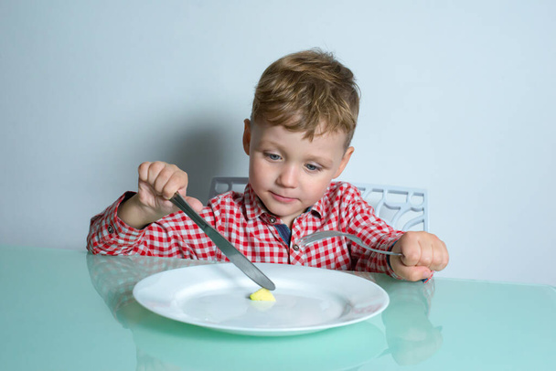 Little boy eating a small portion of food. - Photo, Image