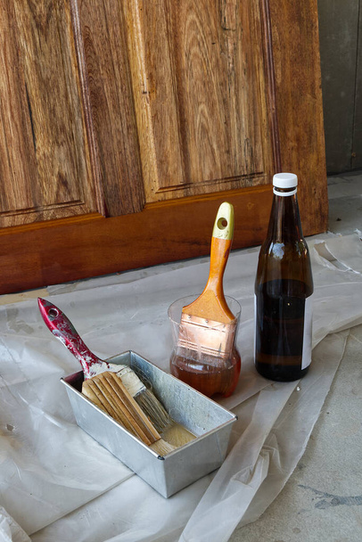 Paint Brush in the Plastic Jar contained Lacquer Prepared for Wooden Door Lacquering. - Photo, Image
