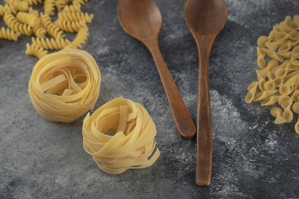 Raw dry nest pasta on a marble background - Photo, Image