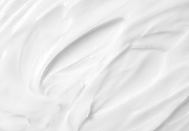 Textura de crema de belleza. Loción blanca, crema hidratante, cuidado de la piel cosméticos aplicación fondo. - Foto, Imagen