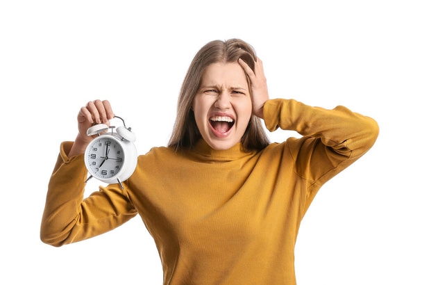 Stressed young woman with clock on white background - Photo, Image