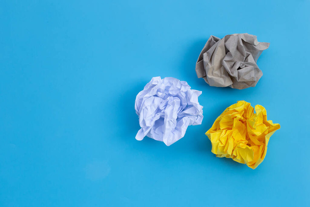 Crumpled paper balls on blue background.  - Photo, Image