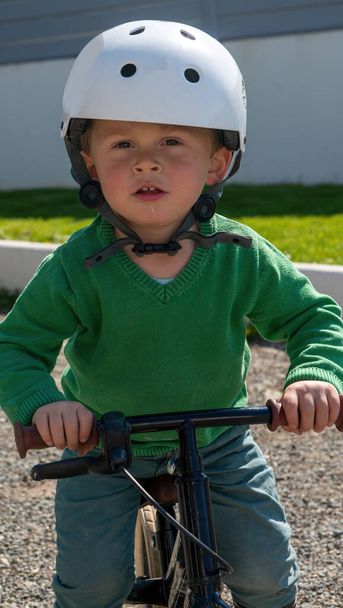 Cheerful little boy riding a bicycle - Photo, Image
