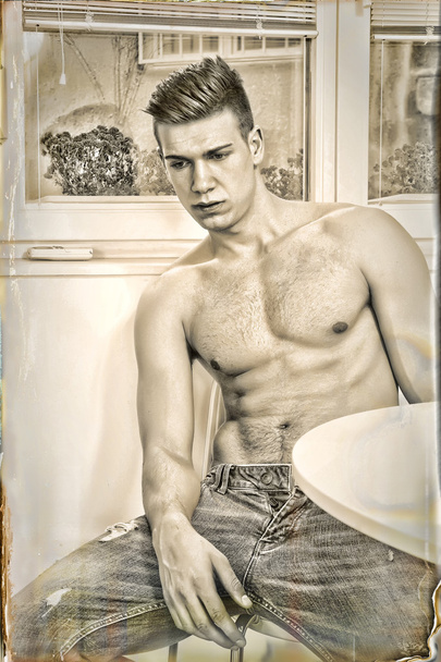 sad pensive lonely guy in jeans with naked chest sitting - Foto, imagen