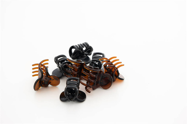 Bunch of plastic amber hair claws close up studio shot isolated on white background. - Fotografie, Obrázek