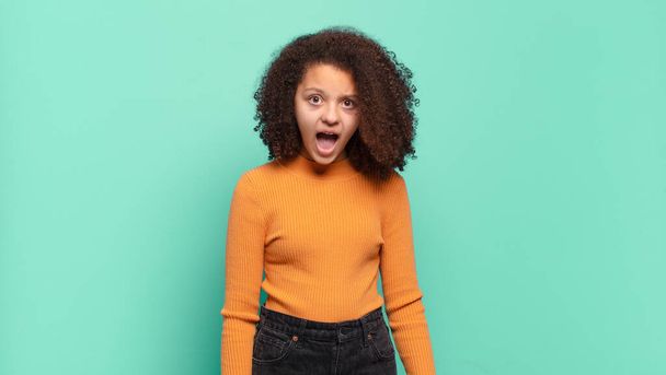 Girl feeling terrified and shocked, with mouth wide open in surprise - Photo, image