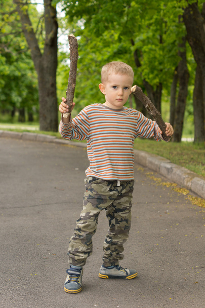 Cute little boy practising stick fighting - Foto, Bild