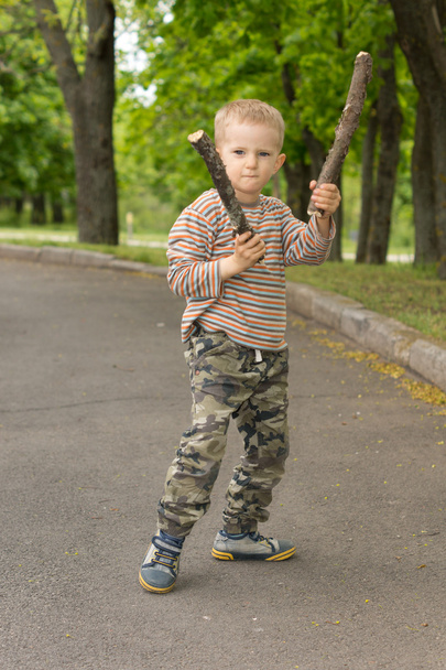 Determined macho little boy stick fighting - Zdjęcie, obraz