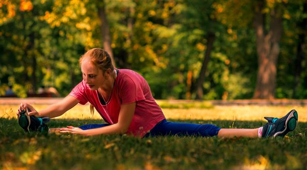 Woman making fitness exercises outdoors - Photo, Image