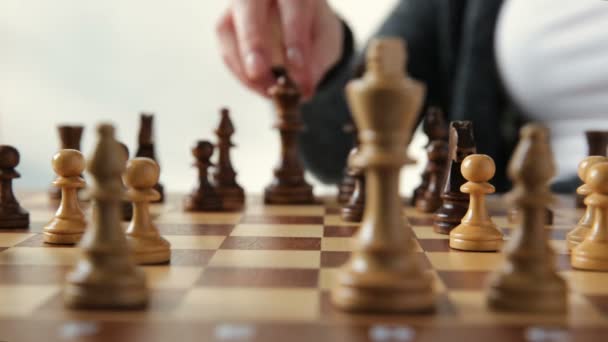 hand of businessman moving chess figure in competition success play. strategy, management or leadership concept - Footage, Video