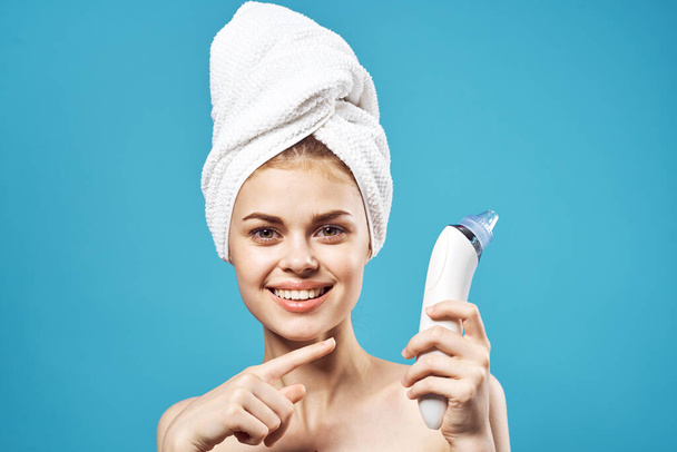 pretty woman naked shoulders towel on head massage blue background - Φωτογραφία, εικόνα