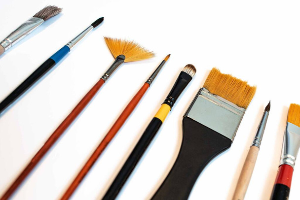Paints and brushes, set of paint brushes isolated on the white background. View from above. Creativity concept. - Photo, Image