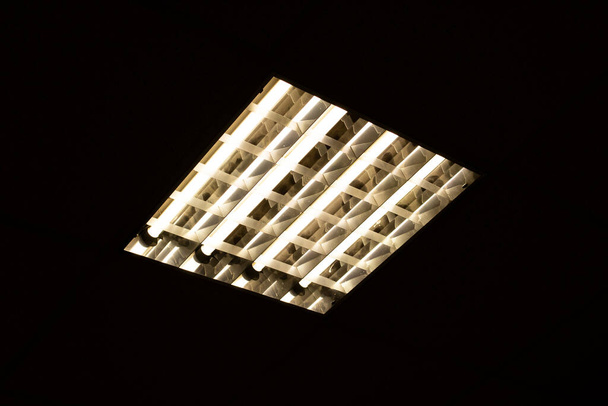 Square fluorescent lamp on the ceiling in the dark - Photo, Image